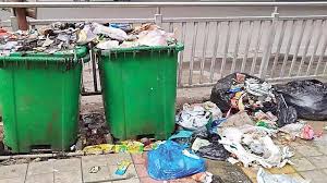Overflowing municipal dustbin